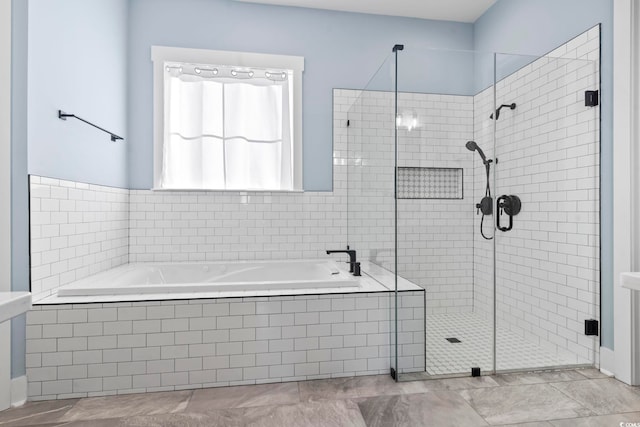 bathroom featuring shower with separate bathtub