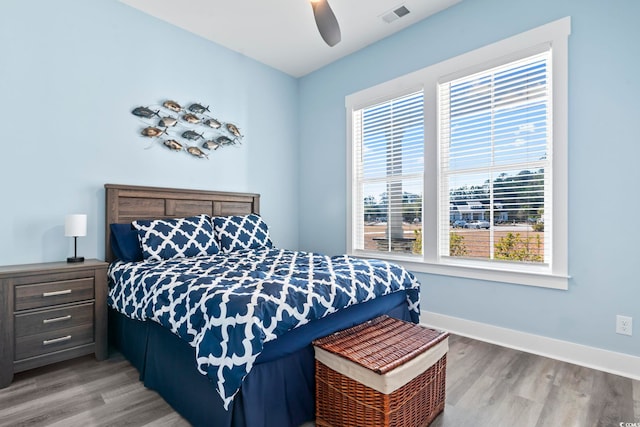 bedroom with wood-type flooring and ceiling fan