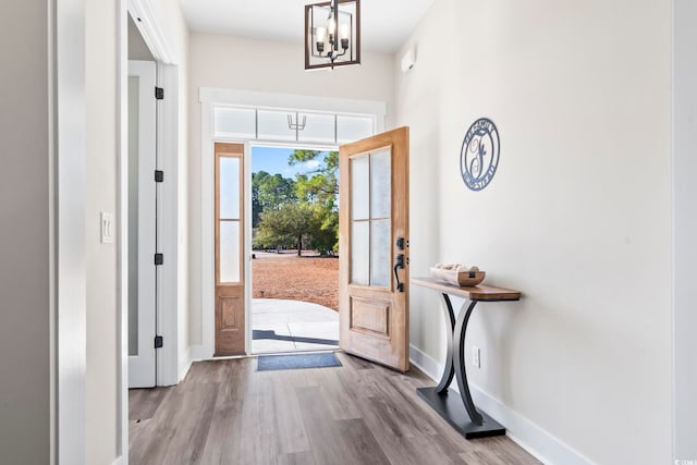 entryway with an inviting chandelier and light hardwood / wood-style floors