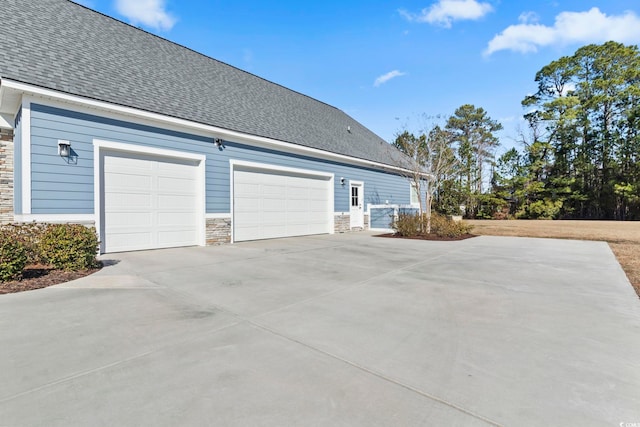 view of side of property with a garage