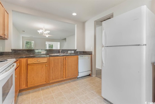 kitchen featuring white appliances, a chandelier, and sink