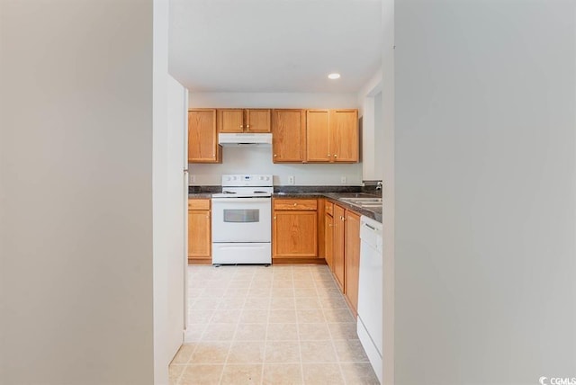 kitchen featuring sink, white appliances, and light tile patterned floors