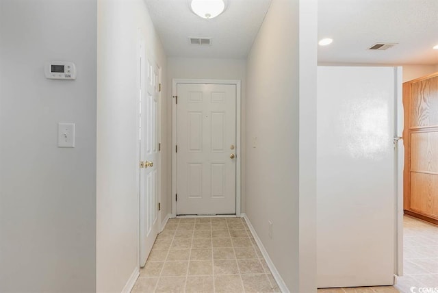 corridor with light tile patterned flooring