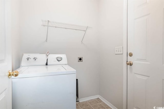 clothes washing area with light tile patterned floors and independent washer and dryer