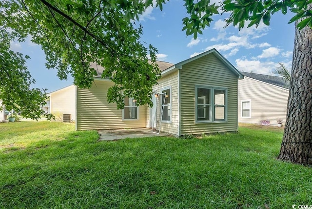 back of property featuring a yard, central air condition unit, and a patio area