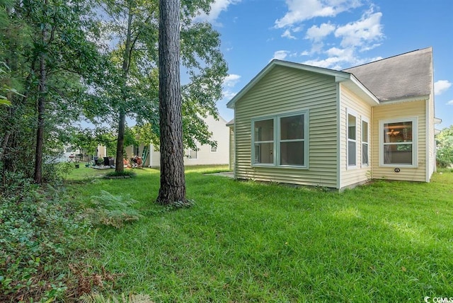 view of side of property with a lawn