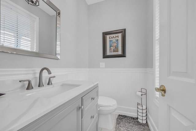 bathroom with toilet, tile patterned floors, and vanity