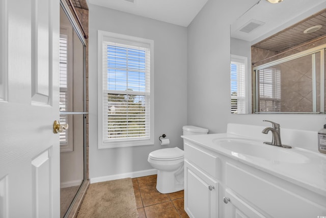 bathroom featuring tile patterned floors, plenty of natural light, toilet, and walk in shower