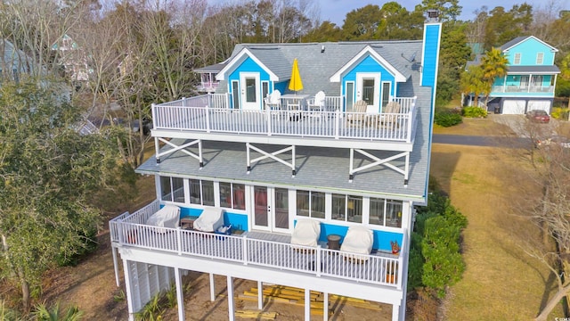 rear view of property featuring a balcony