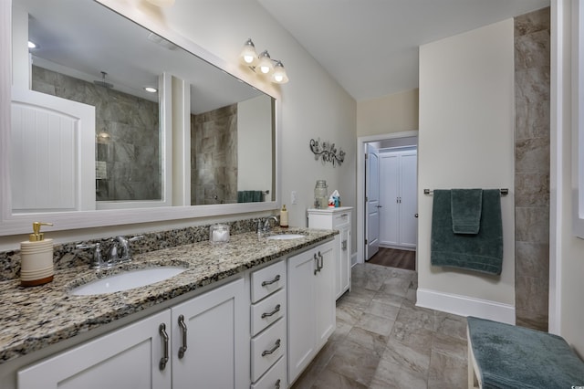 bathroom with vanity and tiled shower