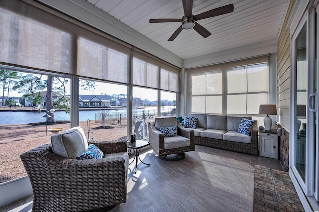 sunroom / solarium featuring a water view, ceiling fan, and plenty of natural light