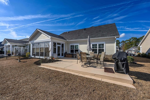 back of house featuring a sunroom and a patio area