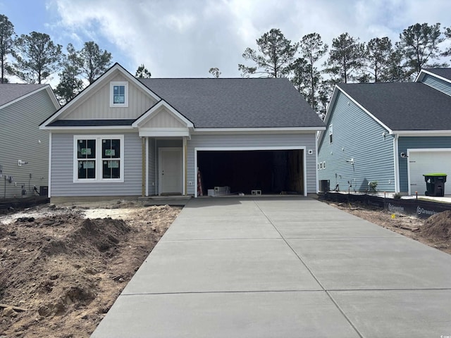 craftsman house featuring a garage, central AC, board and batten siding, and concrete driveway