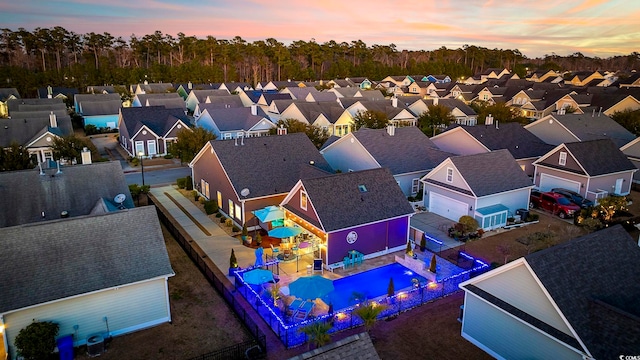 aerial view at dusk featuring a residential view