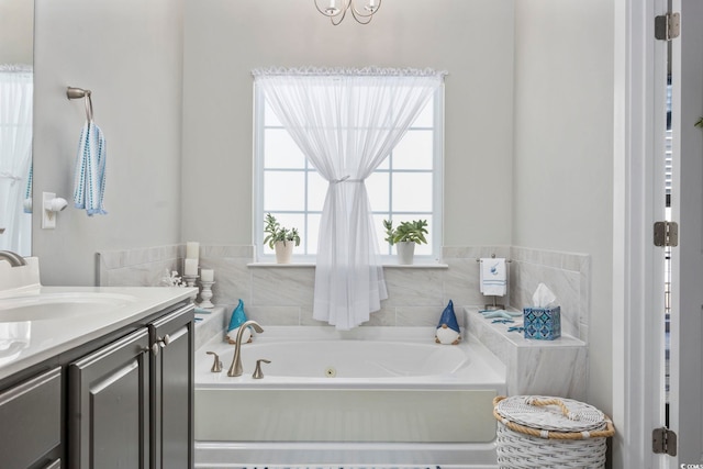 bathroom with a whirlpool tub and vanity