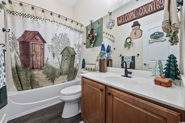 bathroom featuring shower / bathtub combination with curtain, vanity, toilet, and wood finished floors