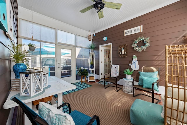 sunroom featuring a ceiling fan