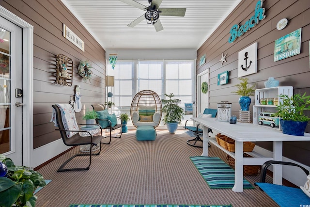 sunroom / solarium with a ceiling fan