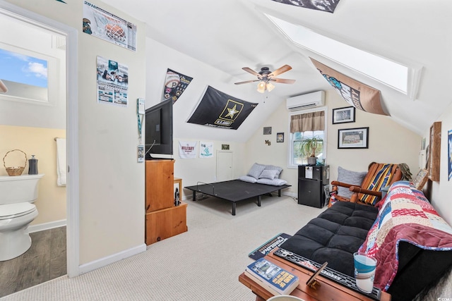 carpeted living room with lofted ceiling with skylight, ceiling fan, baseboards, and an AC wall unit