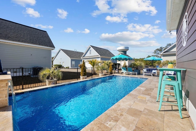 view of swimming pool featuring a patio, fence, a fenced in pool, and central air condition unit