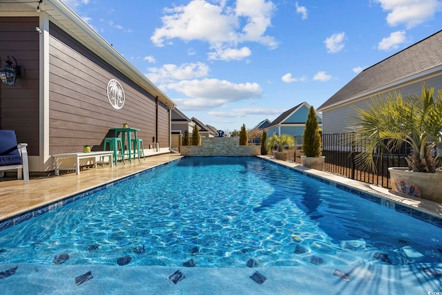 view of pool with a fenced in pool, fence, and a patio