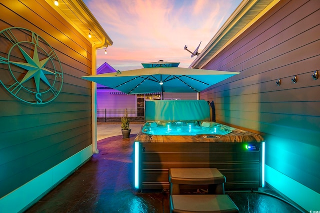 view of patio / terrace featuring a hot tub and fence