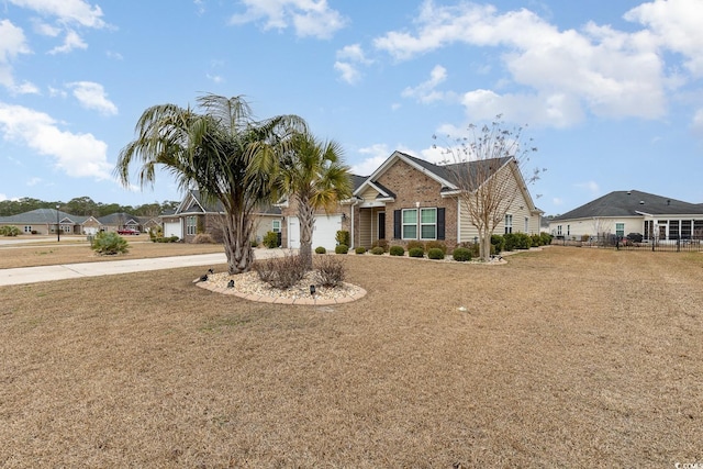 ranch-style house featuring brick siding, concrete driveway, a garage, and a front yard