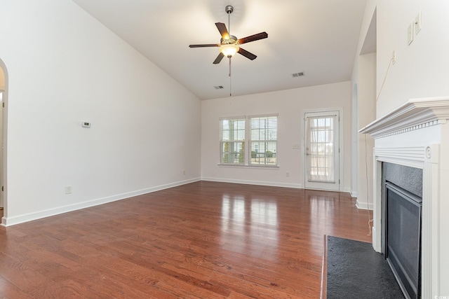 unfurnished living room with a ceiling fan, a fireplace with flush hearth, wood finished floors, and visible vents