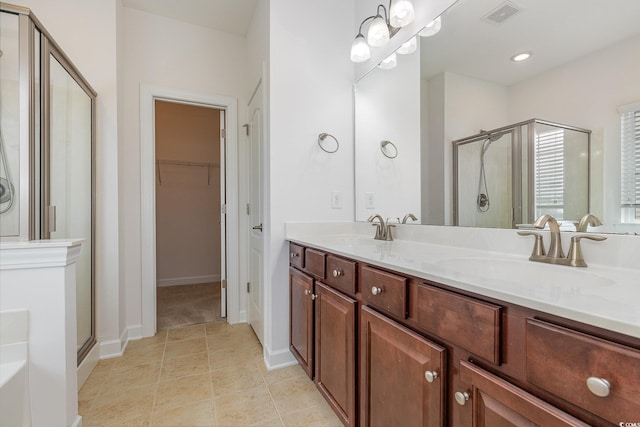 full bath with tile patterned floors, visible vents, a stall shower, and a sink