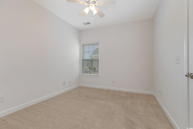 empty room with baseboards, light carpet, visible vents, and ceiling fan