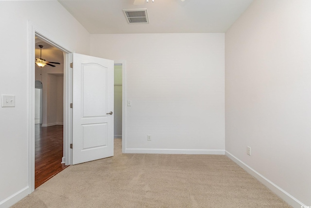 unfurnished room featuring visible vents, arched walkways, carpet flooring, and a ceiling fan