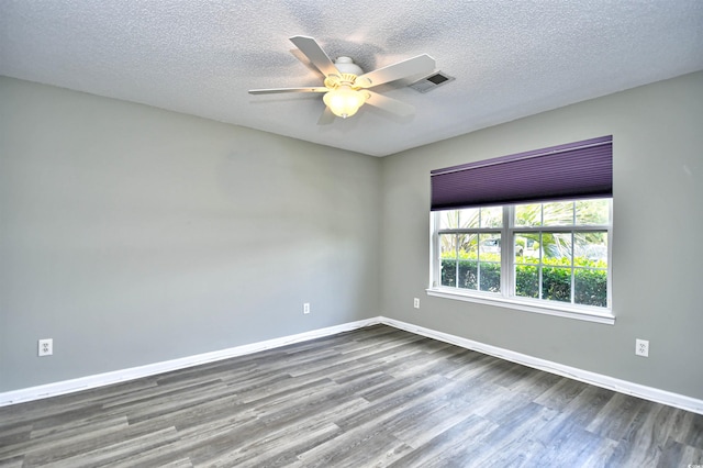 unfurnished room featuring dark wood-style floors, baseboards, a ceiling fan, and a textured ceiling