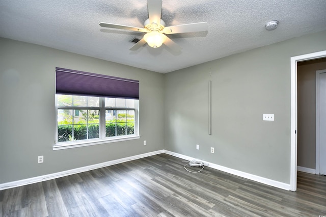 unfurnished room with dark wood finished floors, a smoke detector, baseboards, a ceiling fan, and a textured ceiling