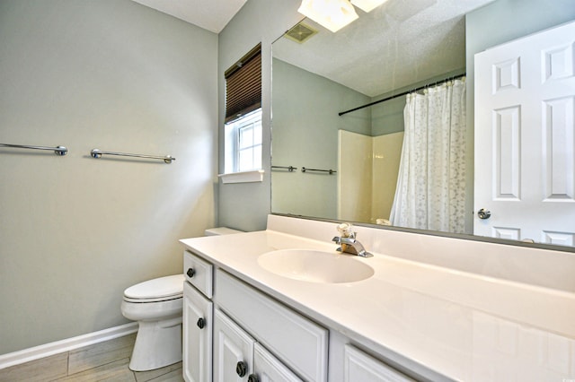 bathroom featuring toilet, vanity, baseboards, wood finished floors, and curtained shower