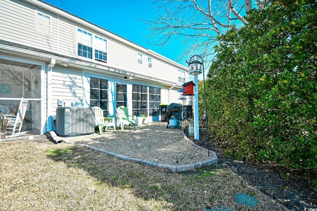 back of property featuring central AC