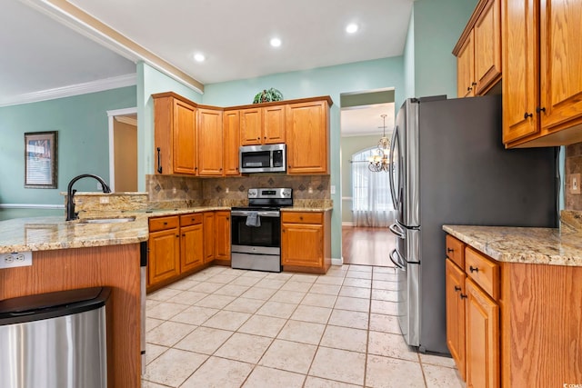 kitchen featuring sink, light tile patterned floors, appliances with stainless steel finishes, light stone counters, and kitchen peninsula