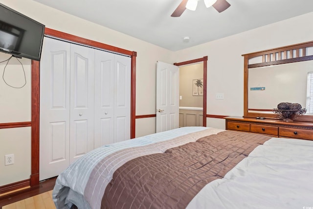 bedroom with ceiling fan, hardwood / wood-style floors, and a closet