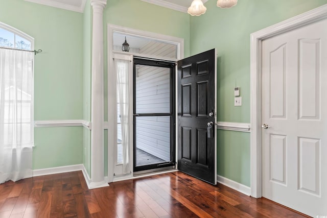 foyer with ornate columns, ornamental molding, baseboards, and dark wood finished floors