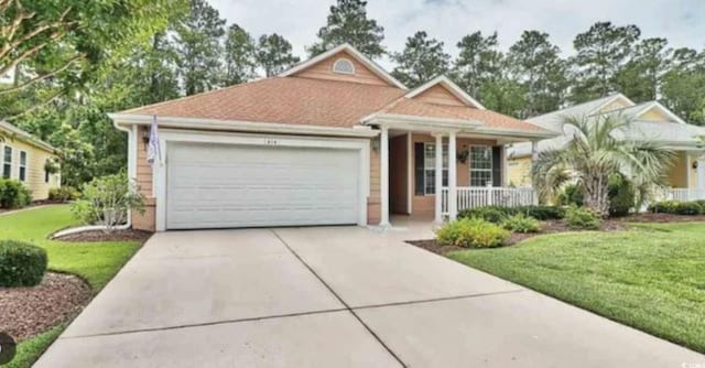 view of front of house featuring a porch, a front yard, driveway, and an attached garage