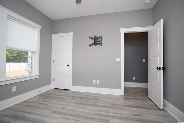 unfurnished bedroom featuring baseboards and light wood finished floors