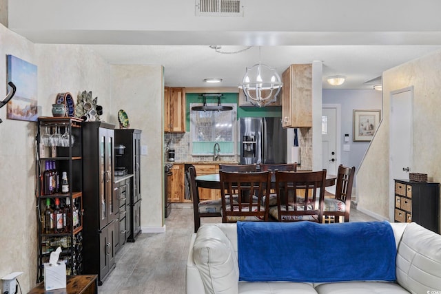 dining room featuring sink and light wood-type flooring