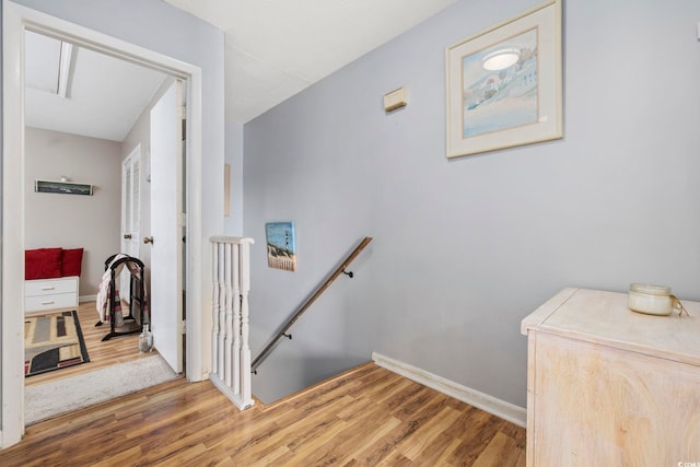 stairs featuring hardwood / wood-style flooring