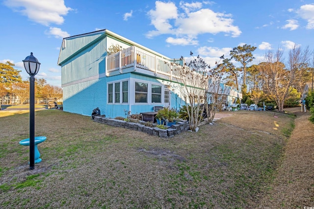 view of property exterior featuring a lawn