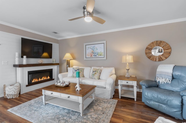 living room featuring crown molding, ceiling fan, and dark hardwood / wood-style flooring