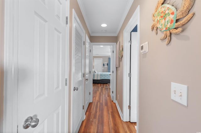 corridor featuring ornamental molding and dark hardwood / wood-style flooring