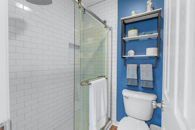 bathroom featuring walk in shower and toilet