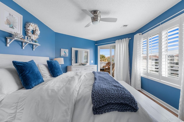 bedroom featuring a textured ceiling and ceiling fan