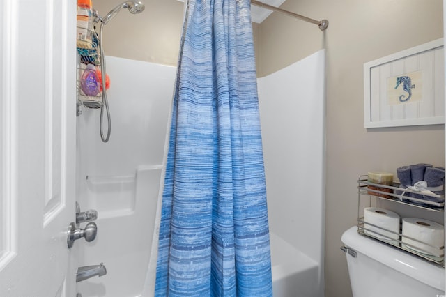 bathroom with shower / tub combo with curtain and toilet