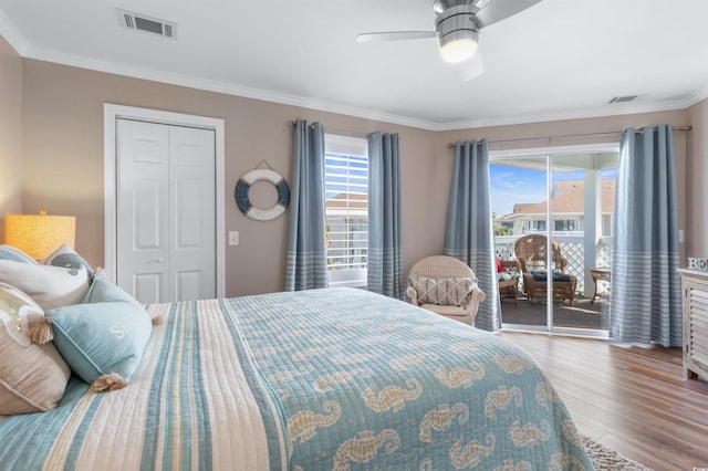 bedroom with crown molding, ceiling fan, access to exterior, wood-type flooring, and a closet