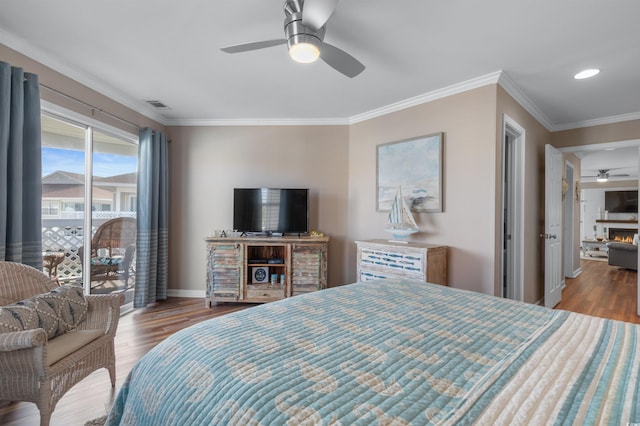 bedroom featuring wood-type flooring, ceiling fan, and crown molding